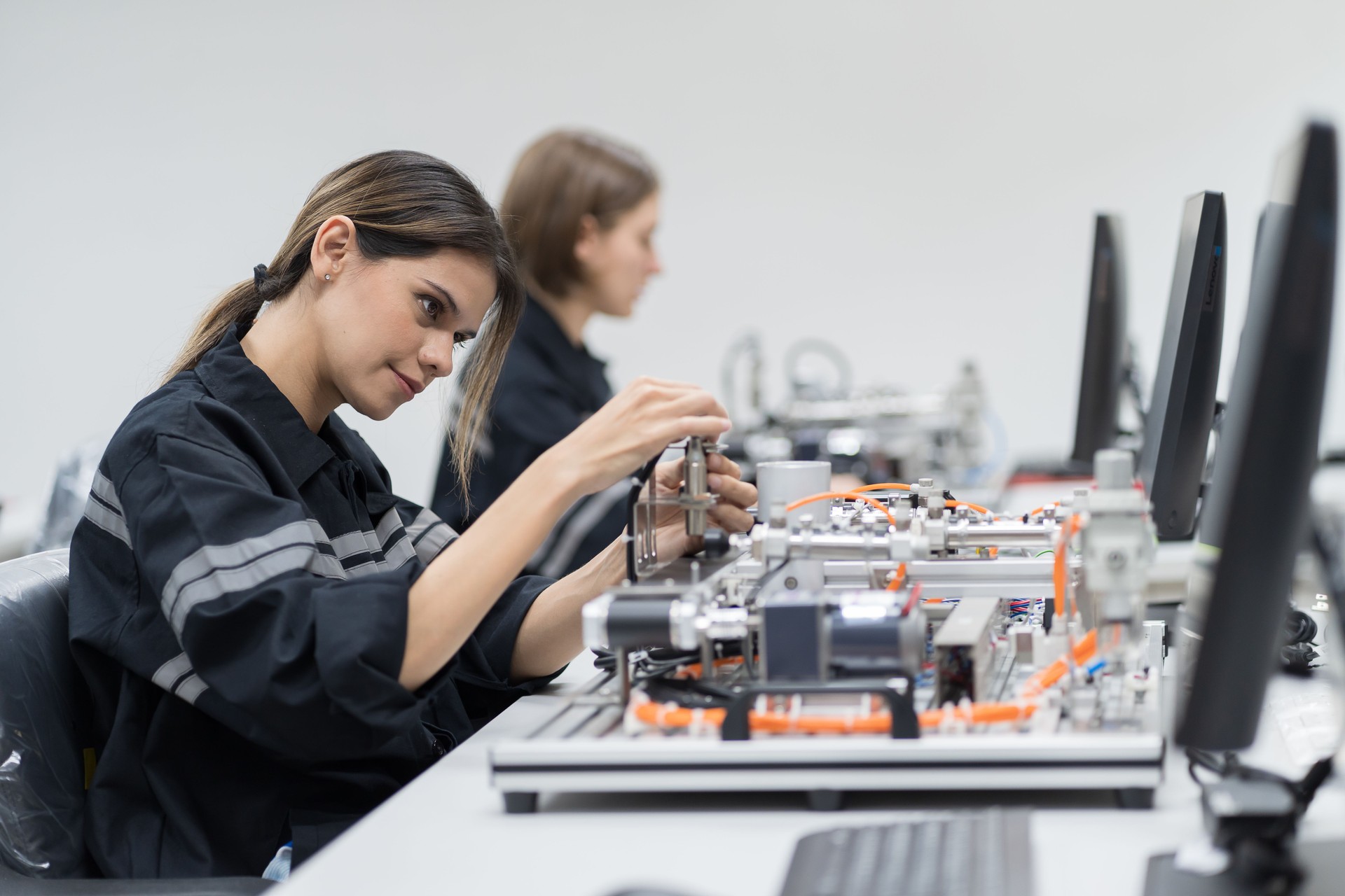 Assembling computer hardware. Engineer assembling circuit board in technology lab. Team engineer training Programmable logic controller with AI robot training kit and mechatronics engineering